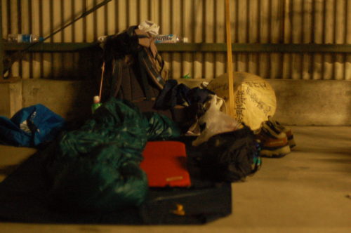 JR国分駅自転車置場で寝た時の様子　寝袋や道具が散らかっています